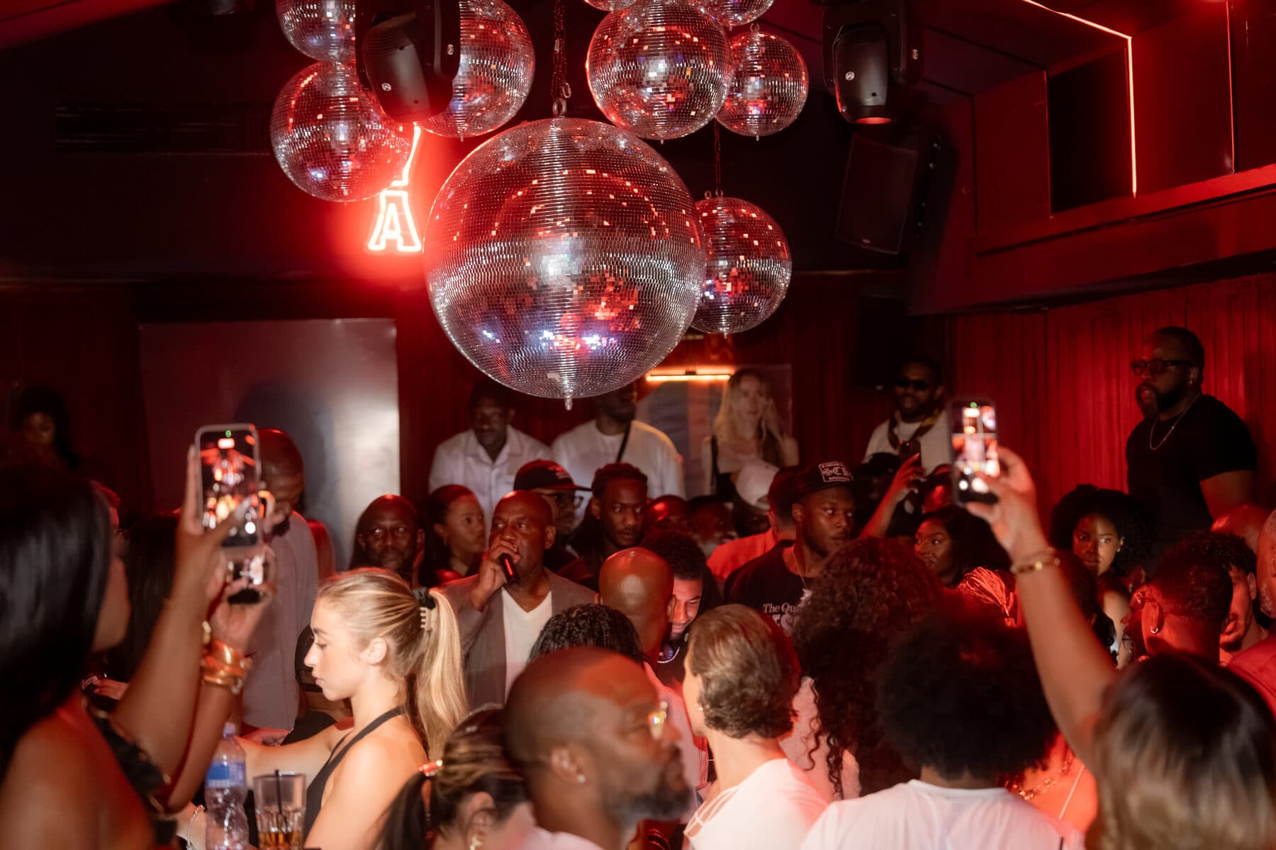Guests dancing under disco balls at a Culturin night in Cannes