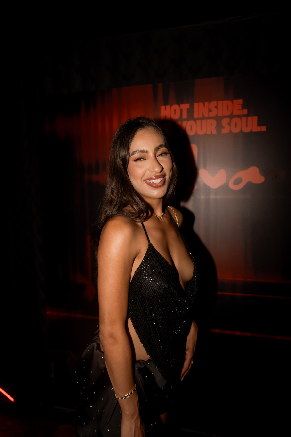 Guest smiling against a branded backdrop