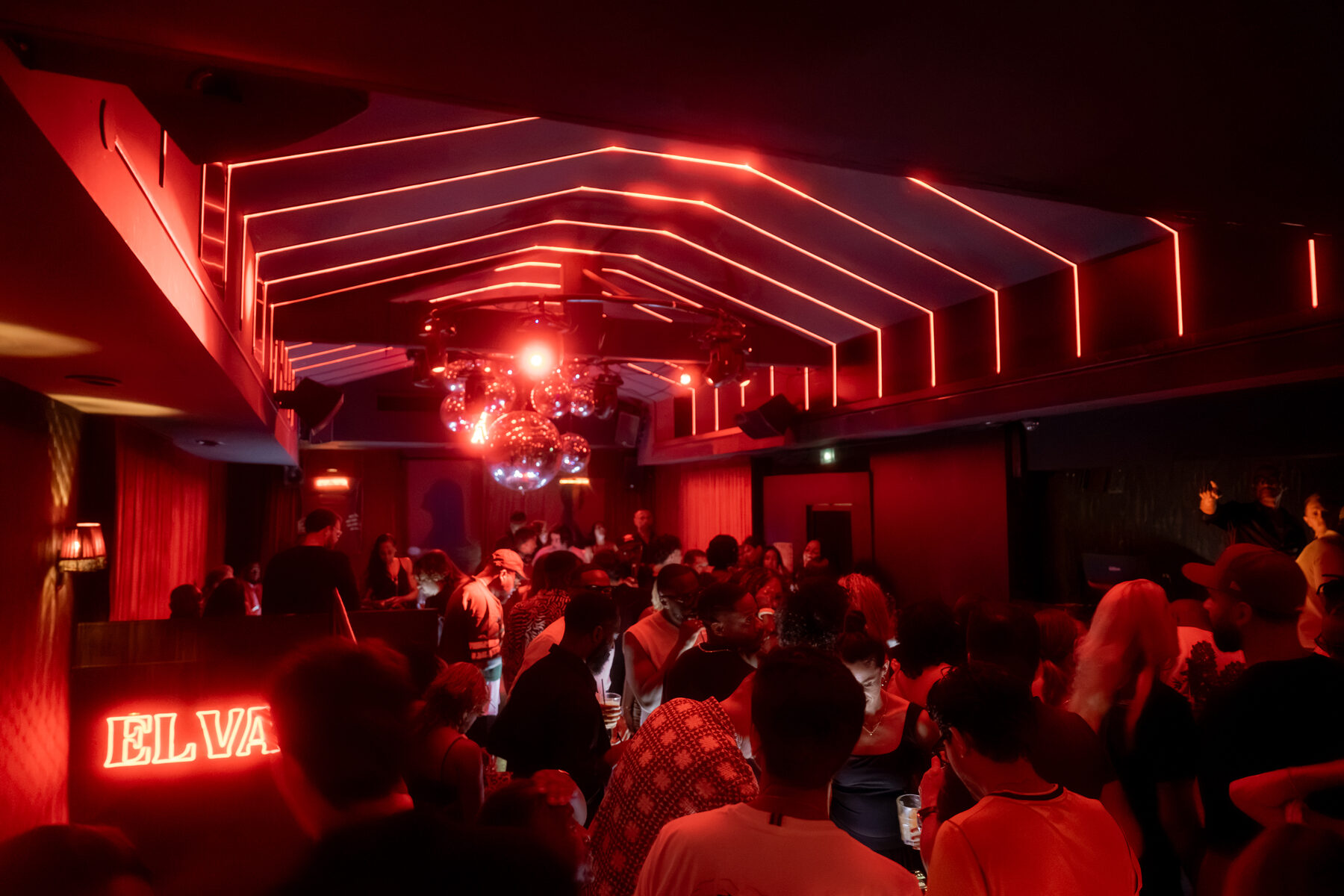 Wide view of the venue in warm red light