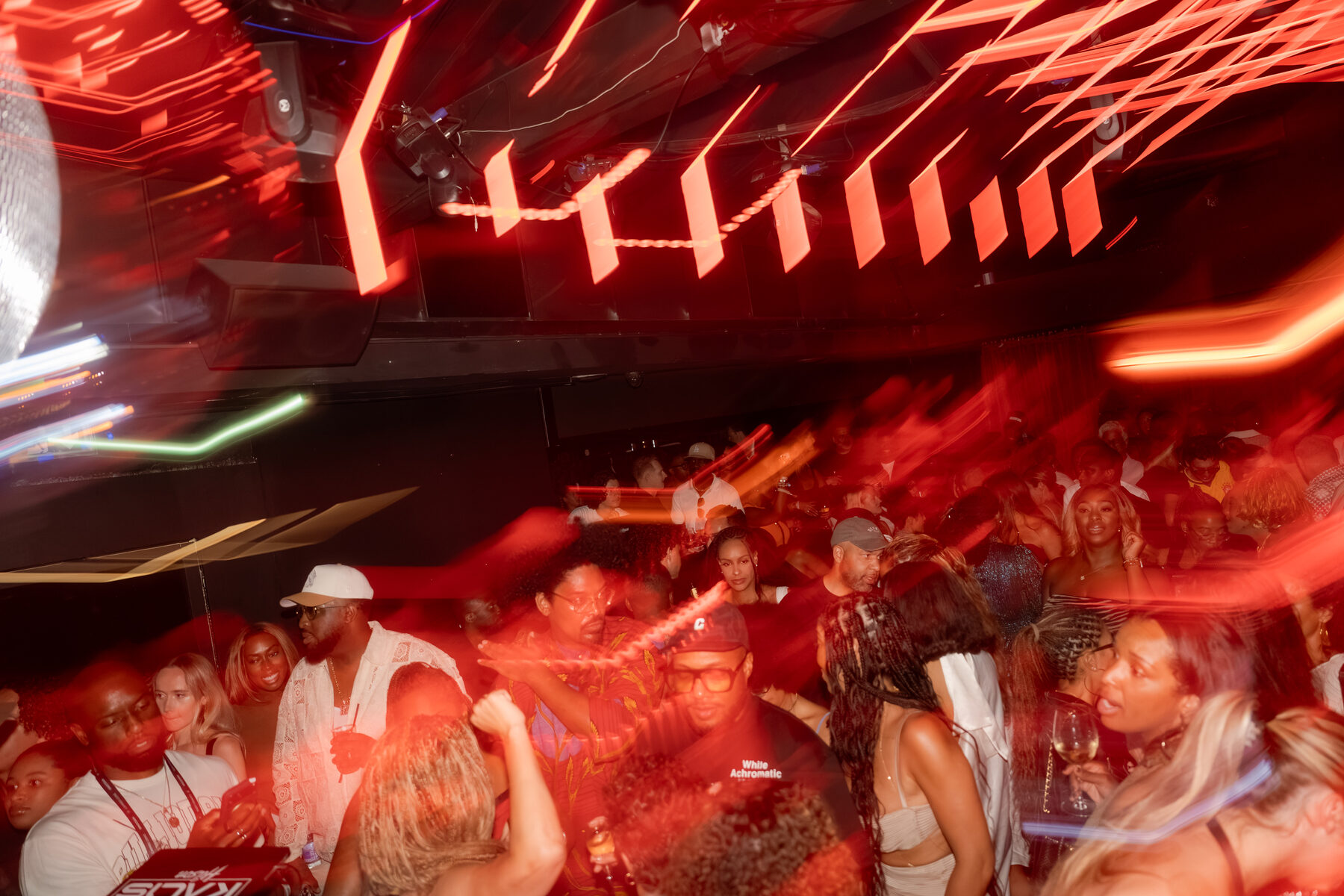Red-lit crowd on the dancefloor